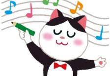 五線譜に鉛筆で音符を書く白黒猫の音楽家を描いた可愛いイラスト