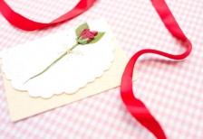 赤いリボンと花の飾りのついて手紙を撮影した写真。バレンタインデーのデザインに。